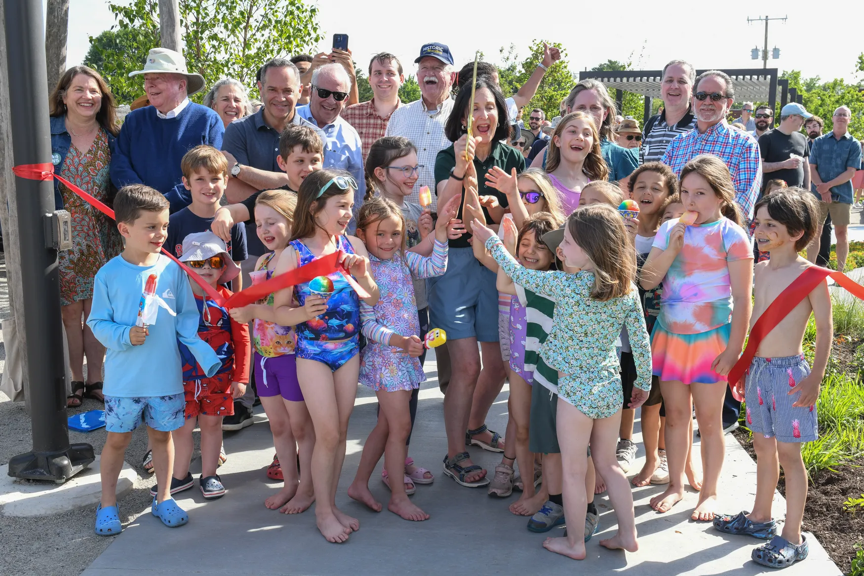 Community members and children gathered at a ribbon-cutting celebration at the Pattern District in Newton Upper Falls, MA.