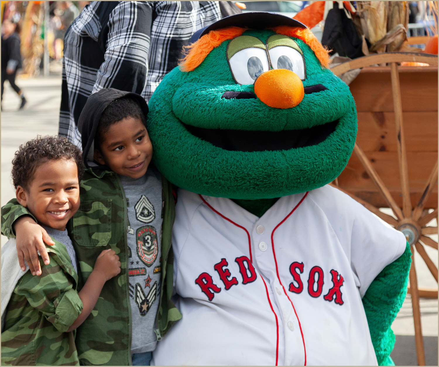 Children posing with the Boston Red Sox mascot at a community event at the Pattern District in Newton Upper Falls, MA.