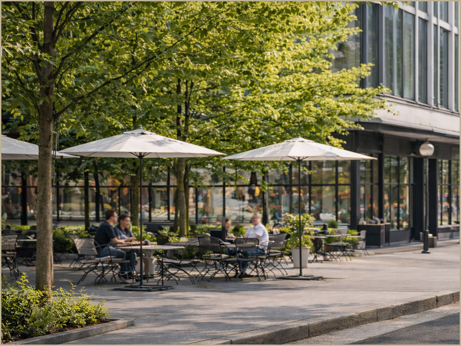 Outdoor dining and pedestrian seating at the Pattern District in Newton Upper Falls, MA, featuring tree-lined sidewalks and ground-floor retail storefron