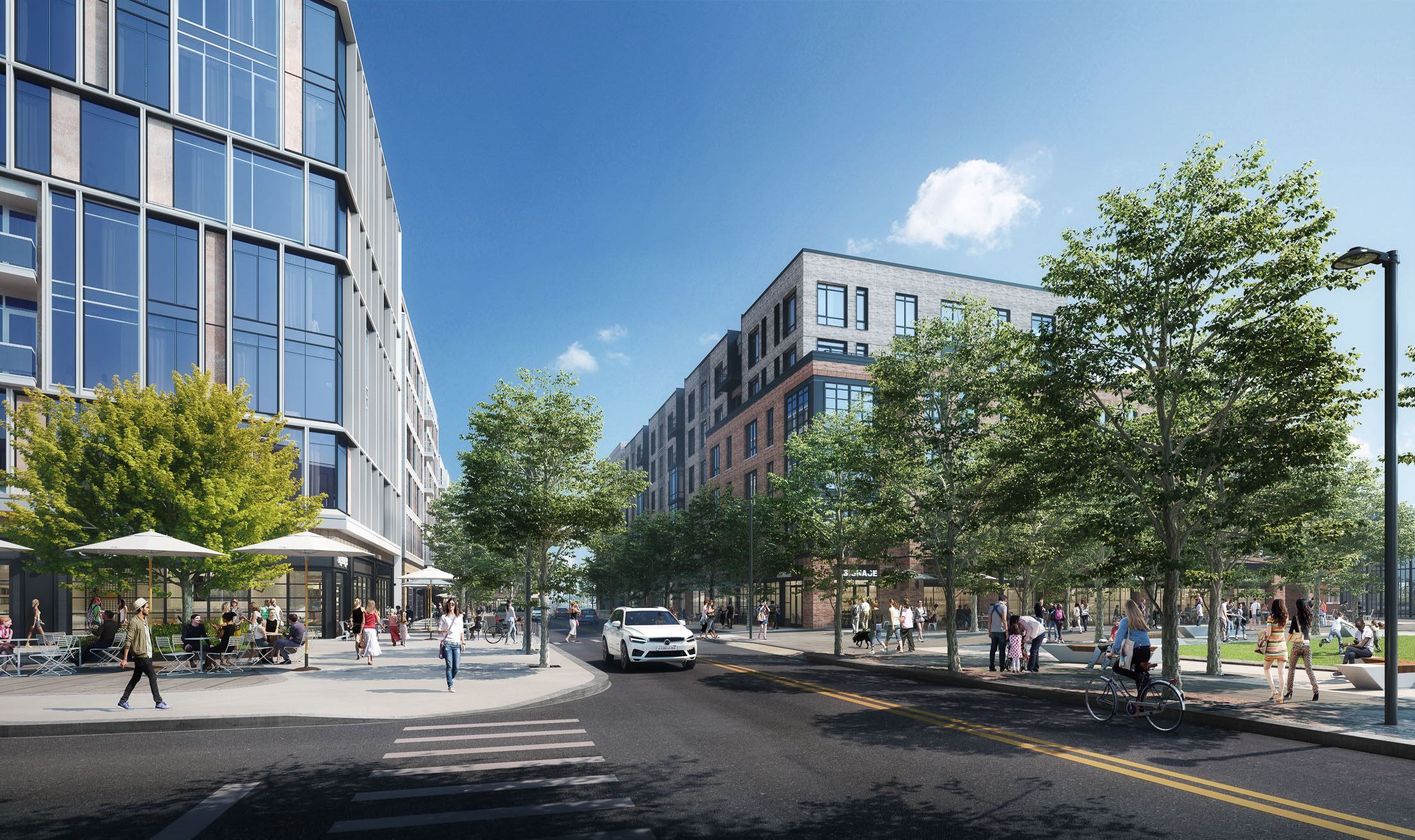 Street-level view of the Pattern District in Newton Upper Falls, MA, featuring walkable streets, outdoor dining, and modern mixed-use buildings.